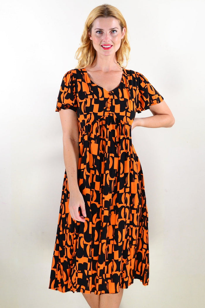 Orange and black printed tunic dress by Hourglass, featuring a stylish design and comfortable fit, shown on a model.
