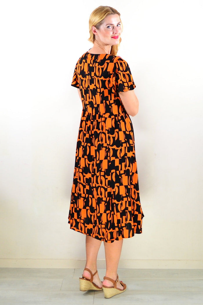 Orange and black printed tunic dress by Hourglass, featuring a stylish and comfortable design with a flowing silhouette.