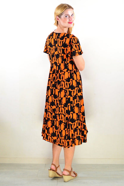 Orange and black printed tunic dress by Hourglass, featuring a stylish and comfortable design with a flowing silhouette.
