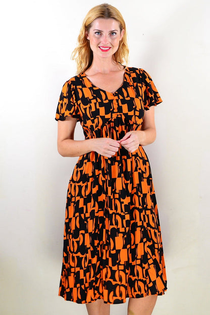 Orange and black printed tunic dress by Hourglass, featuring a stylish and comfortable design with a flowing silhouette.