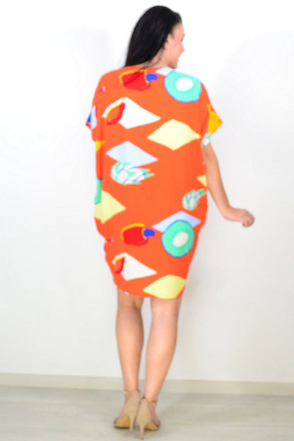 Orange Candy Lane tunic dress by Red Lotus, featuring a relaxed fit and vibrant color, displayed on a hanger.