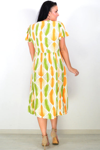 Orange and green patterned Hourglass tunic dress displayed on a mannequin, showcasing its vibrant design and relaxed fit.