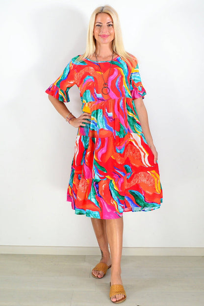 Orange and pink print tunic dress by Hourglass, featuring a flowy fabric and stylish design, displayed on a hanger.