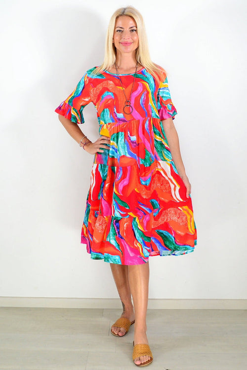 Orange and pink print tunic dress by Hourglass, featuring a flowy fabric and stylish design, displayed on a hanger.