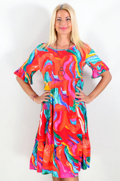 Orange and pink printed tunic dress by Hourglass, showcasing a stylish, flowy design with vibrant floral patterns.