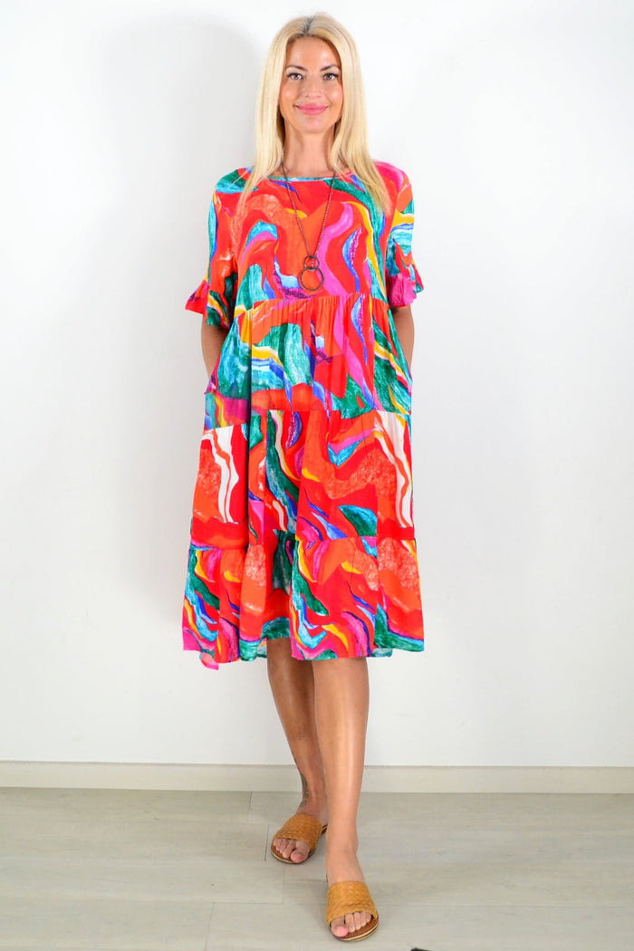 Orange and pink printed tunic dress by Hourglass featuring a flowing design and vibrant floral pattern.