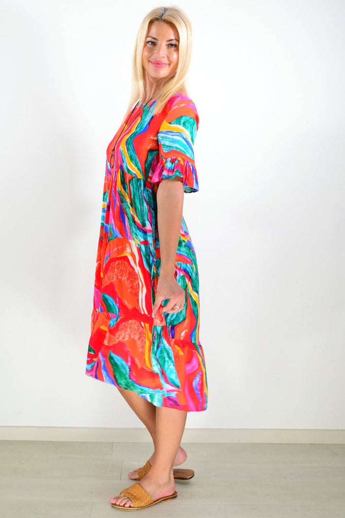 Orange and pink print tunic dress by Hourglass, featuring a flowy silhouette and vibrant pattern, shown on a model.