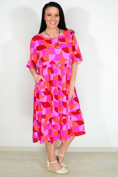 Orange and purple geometric patterned midi dress from New U Collection, stylish tunic with vibrant design and flowing fabric.