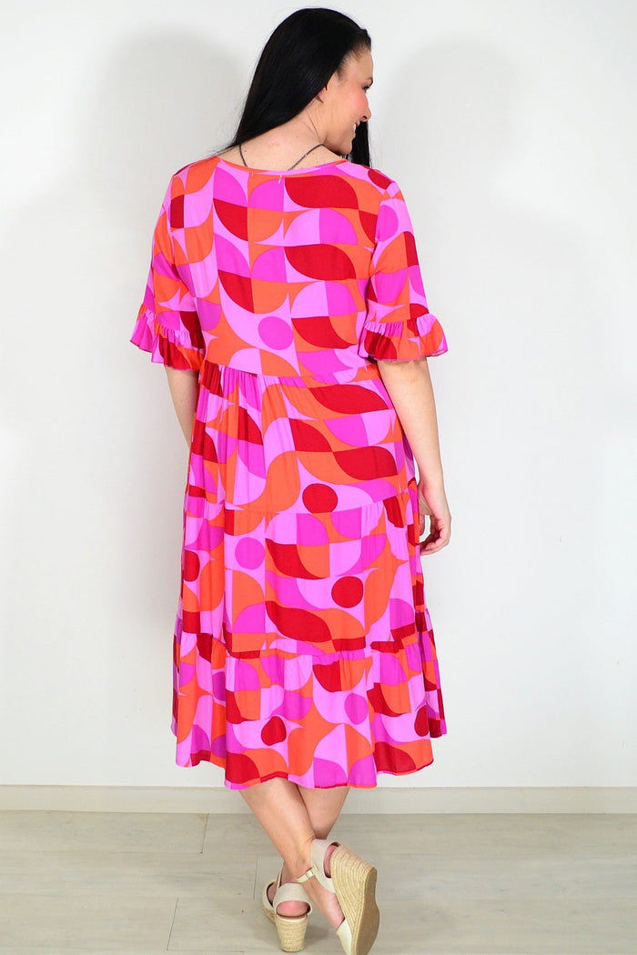 Orange and purple geometric midi dress from New U Collection, stylish tunic with bold pattern and flowing fabric.