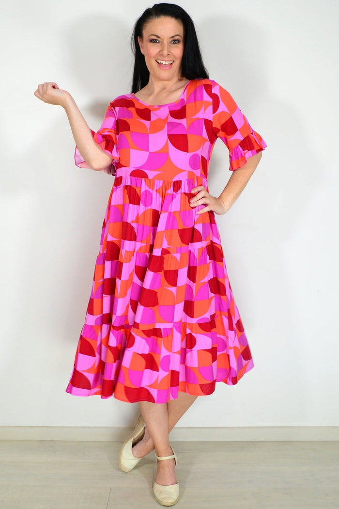 Orange and purple geometric midi dress from New U Collection, stylish tunic with bold pattern and flowing fabric.