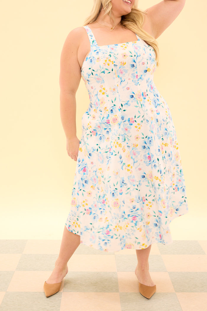 Woman wearing a floral dress against a beige background