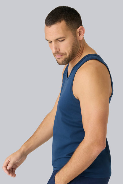 Side view of a man wearing Pima Tank in True Navy