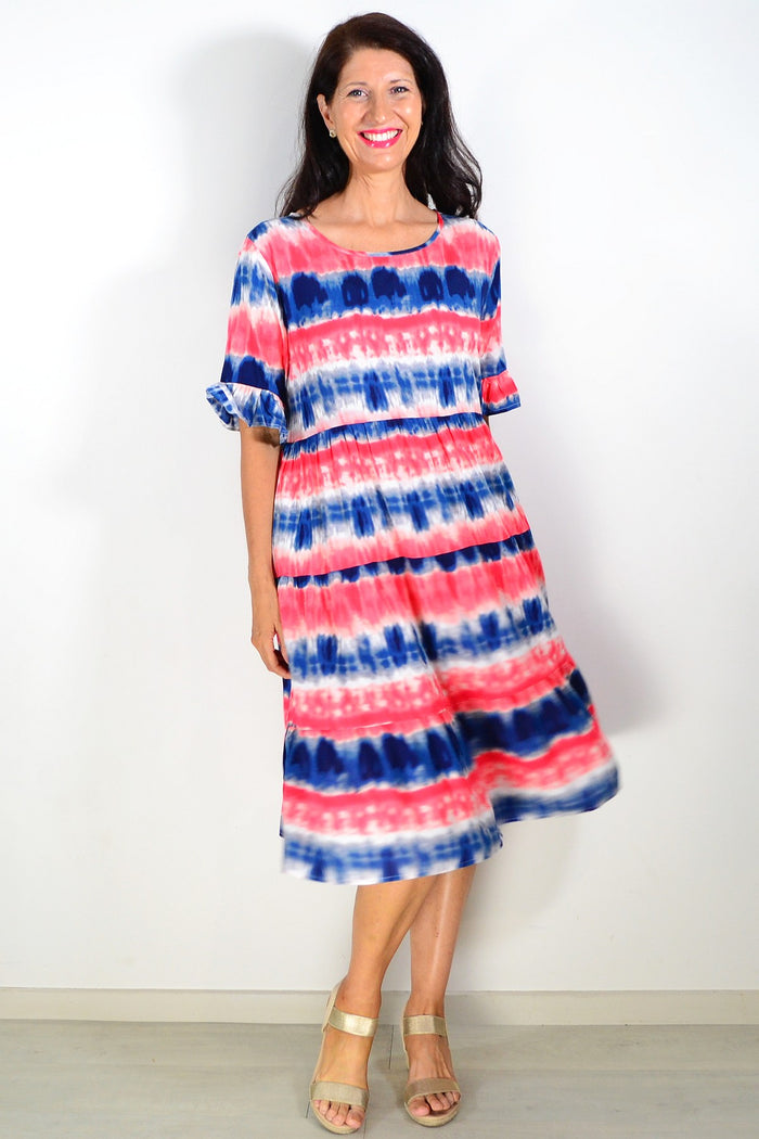 Pink and blue tie-dye Hourglass tunic dress with long sleeves and relaxed fit, displayed on a hanger.