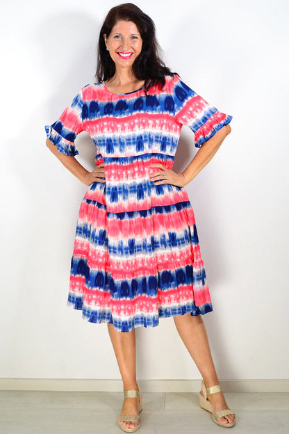 Pink and blue tie-dye tunic dress by Hourglass displayed on a hanger with a casual, flowing design and vibrant colors.