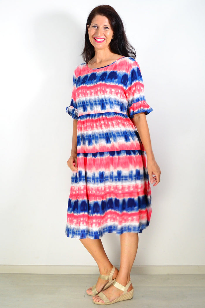 Pink and blue tie-dye tunic dress by Hourglass, showing a relaxed fit with vibrant, swirling patterns and soft fabric.