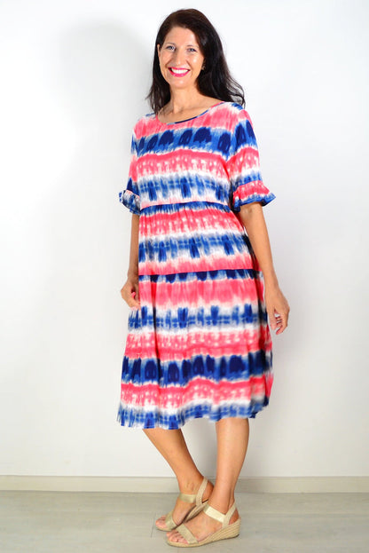 Pink and blue tie-dye tunic dress by Hourglass, showing a relaxed fit with vibrant, swirling patterns and soft fabric.
