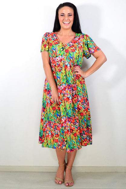 Hourglass Poppy Field Tunic Dress displayed on a mannequin with a floral pattern and flowing fabric, perfect for casual wear.