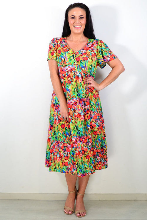 Hourglass Poppy Field Tunic Dress displayed on a mannequin with a floral pattern and flowing fabric, perfect for casual wear.