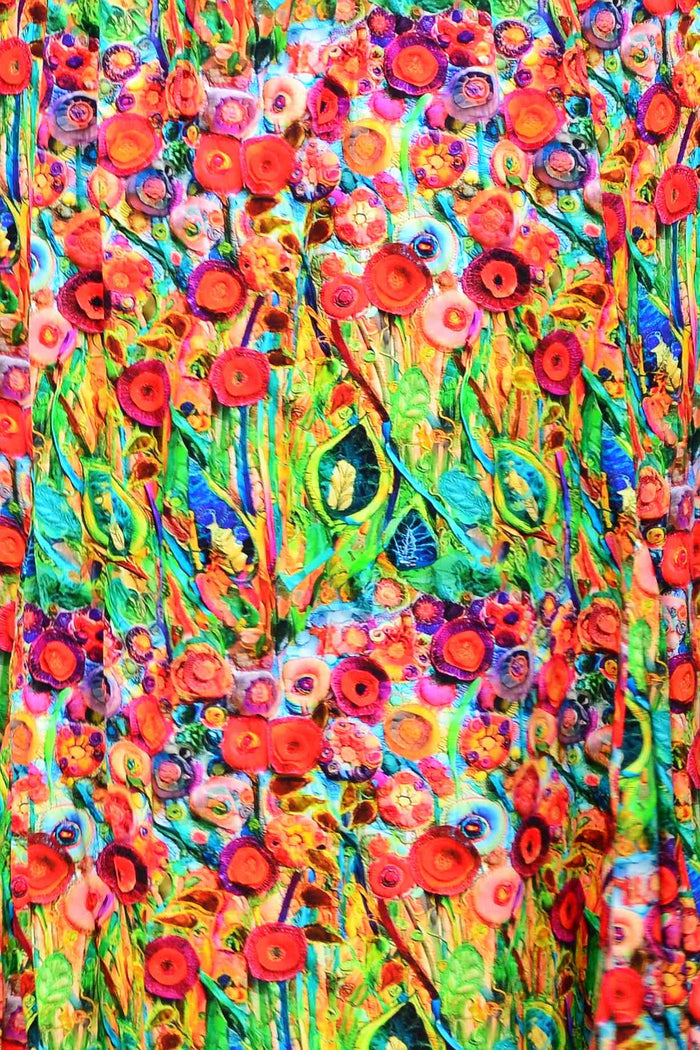 Hourglass Poppy Field Tunic Dress hanging on a rack with floral pattern and flowing fabric, ideal for casual or summer wear.