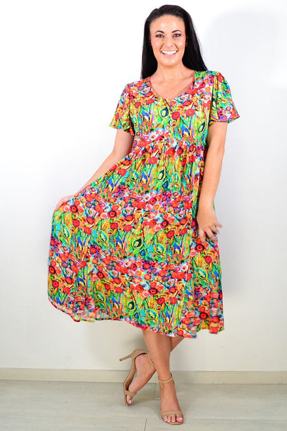 Hourglass Poppy Field Tunic Dress in vibrant floral print, flowing fabric, and relaxed fit displayed on a hanger.