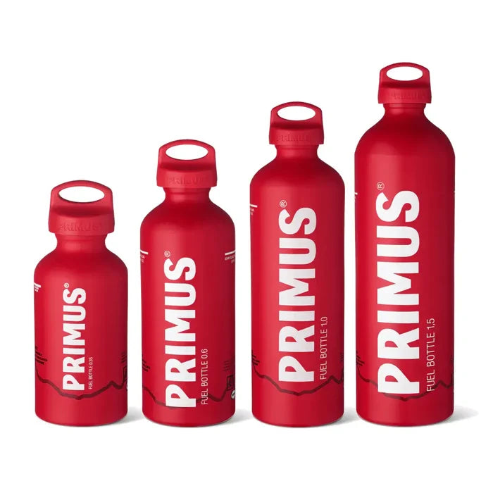 Set of red Primus fuel bottles in the four different sizes on a white background