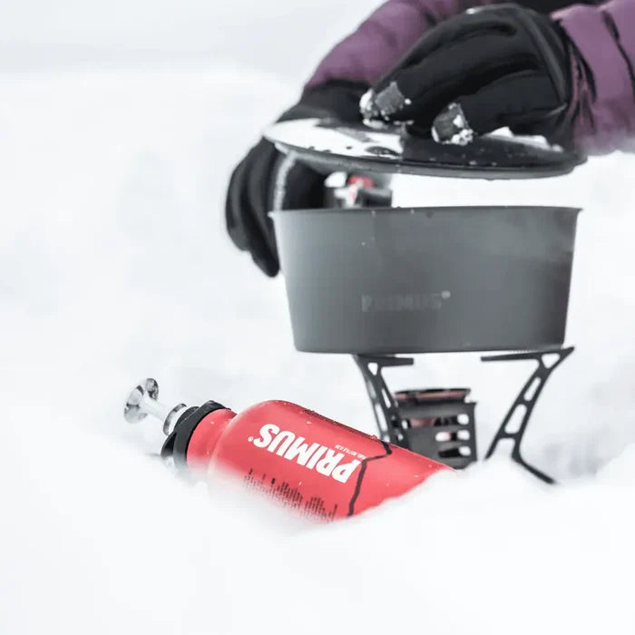 Primus Fuel Bottle being used with an Ergo pump and camp stove in the snow.