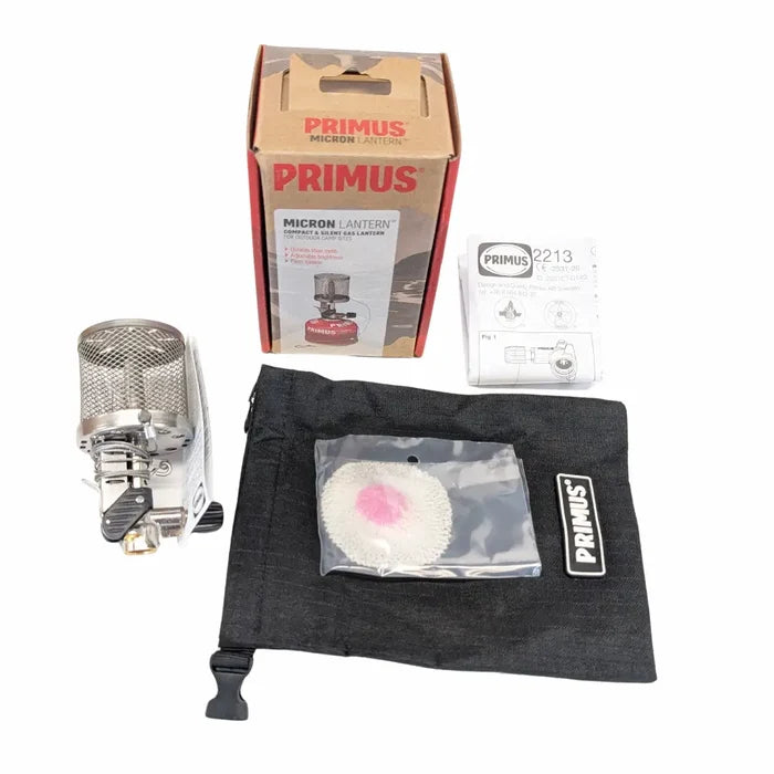 Primus Micron stainless steel lantern with packaging and accessories on a white background