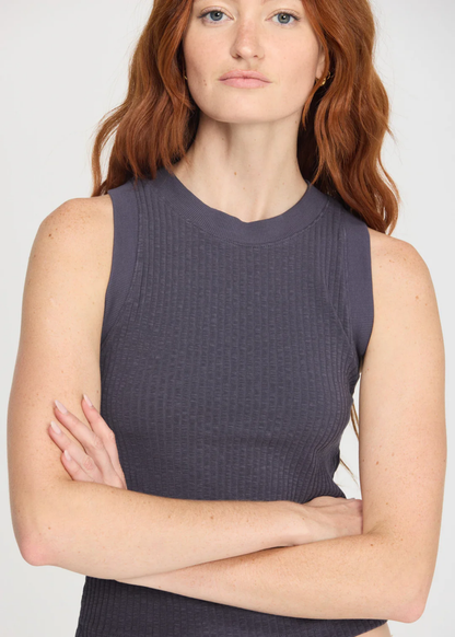 Woman wearing a charcoal grey tank top with a crew neck and a racerback