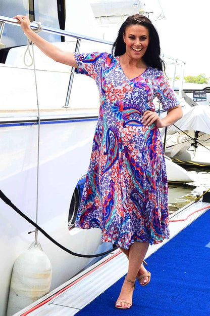 Orientique Radhanagar short sleeve godet tunic dress with flowing fabric and vibrant pattern, perfect for casual or dressy occasions.
