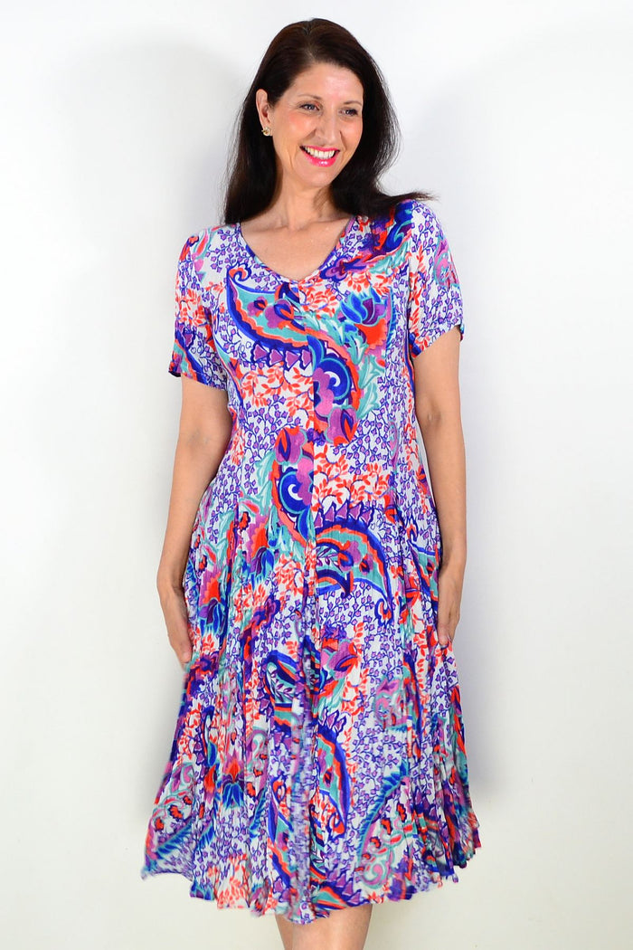 Orientique Radhanagar short sleeve godet tunic dress with flowing fabric and intricate pattern, displayed on a hanger.