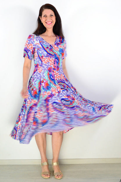 Orientique Radhanagar short sleeve godet tunic dress with floral pattern, flowing fabric, and relaxed fit displayed in the image.