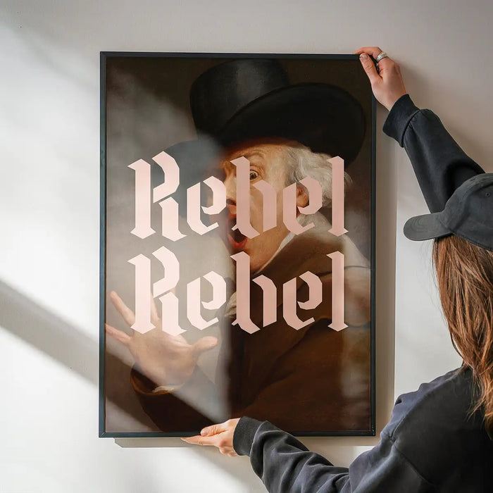 Rebel Rebel Typography Print being hung on a wall in a black frame