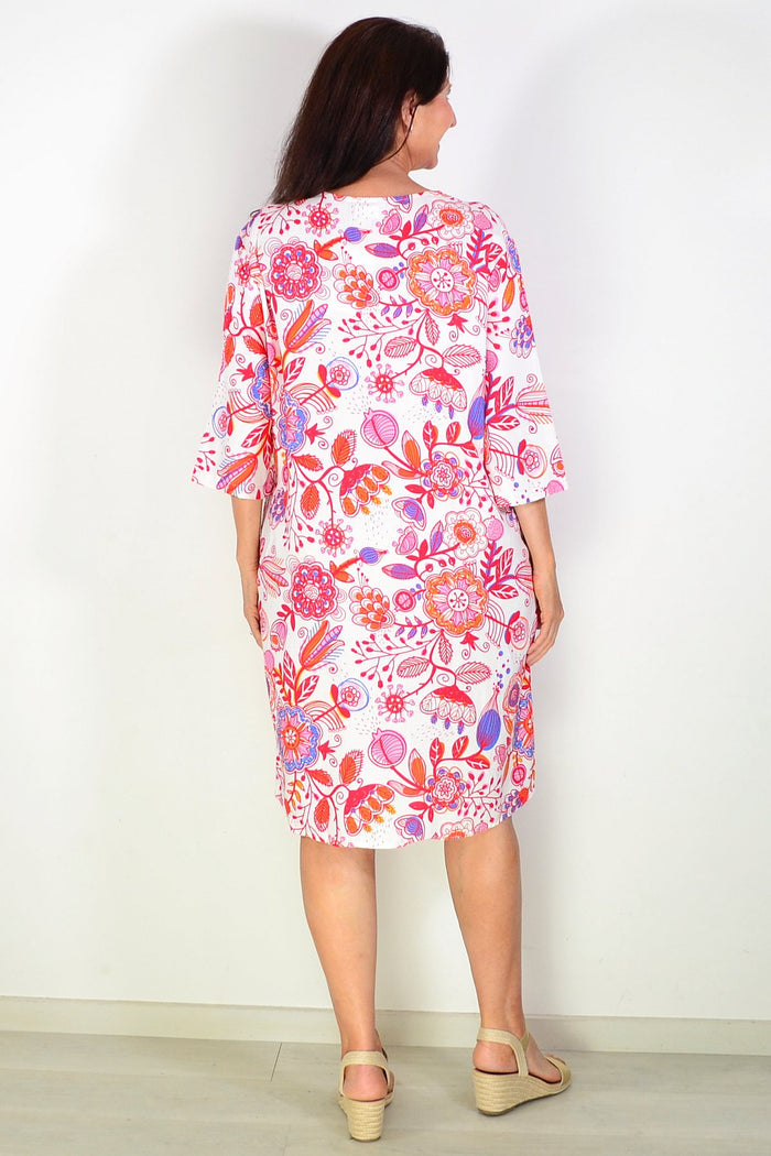 Red floral linen blend tunic by La Mode shown on a hanger with detailed floral print and relaxed fit.