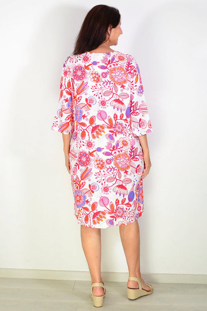 Red floral linen blend tunic by La Mode shown on a hanger with detailed floral print and relaxed fit.