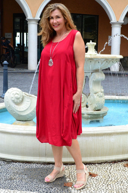 Red sleeveless cocoon tunic dress by Wishstone, featuring a loose fit and simple design, displayed on a hanger.