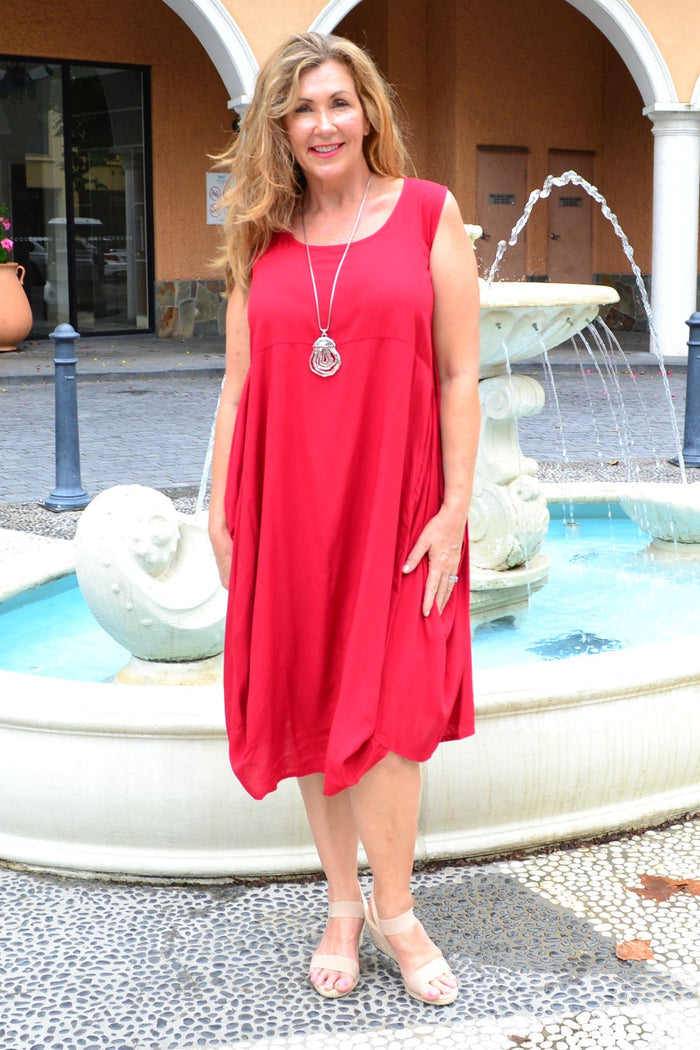Red sleeveless cocoon tunic dress by Wishstone, shown on a hanger with a relaxed fit and simple neckline.