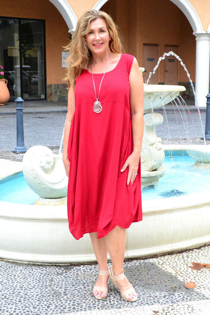 Red sleeveless cocoon tunic dress by Wishstone, shown on a hanger with a relaxed fit and simple neckline.