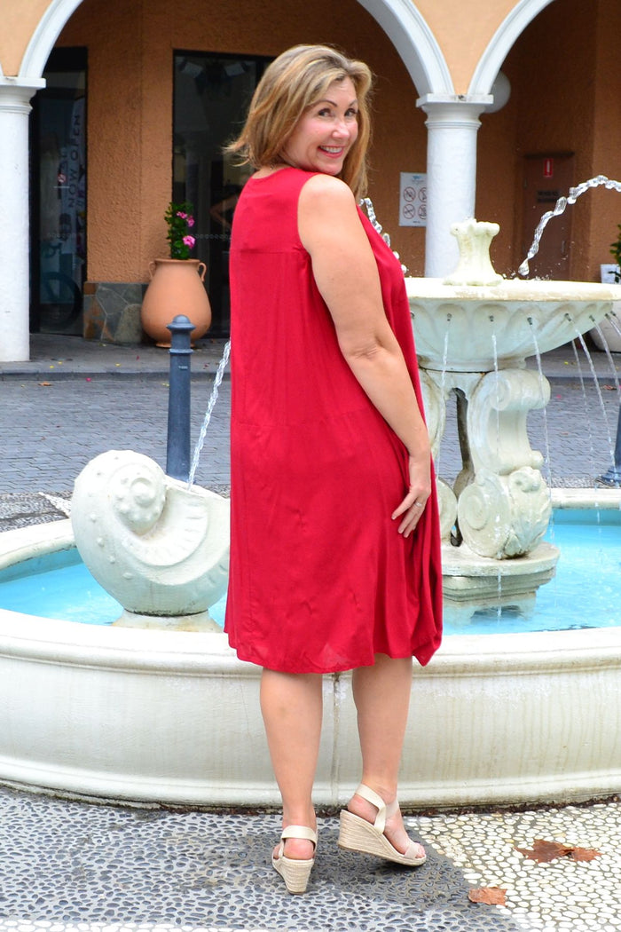 Red sleeveless cocoon tunic dress by Wishstone, featuring a relaxed fit and flowing silhouette, displayed on a neutral background.