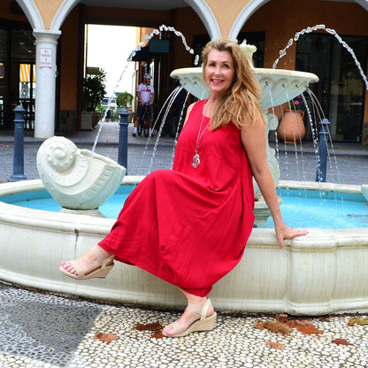 Red sleeveless cocoon tunic dress by Wishstone, shown on a hanger with soft fabric and simple design.
