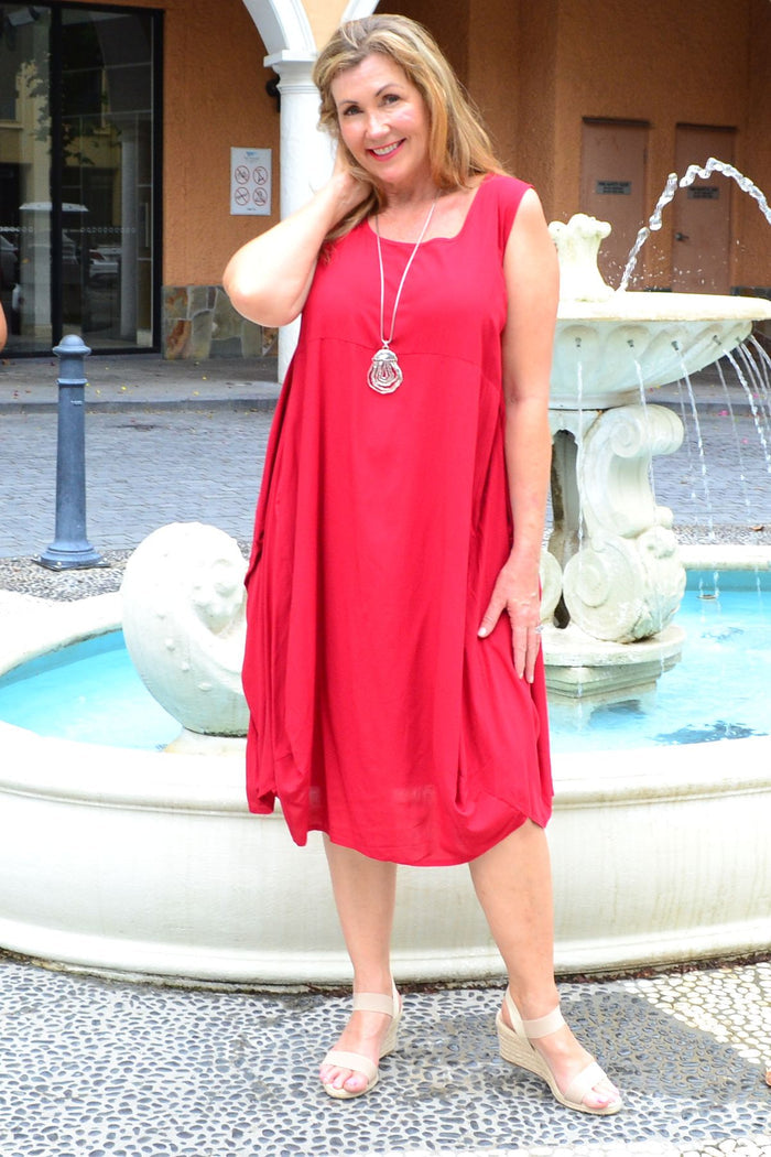 Red sleeveless tunic cocoon dress by Wishstone, featuring a relaxed fit and flowing silhouette, displayed on a hanger.