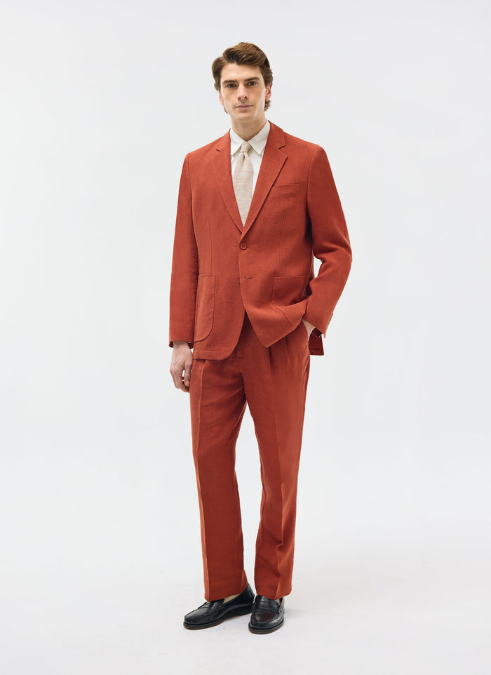 Model wears the Percival relaxed tailored linen blazer and trousers in rust