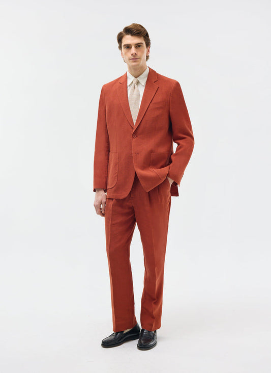 Model wears the Percival relaxed tailored linen blazer and trousers in rust