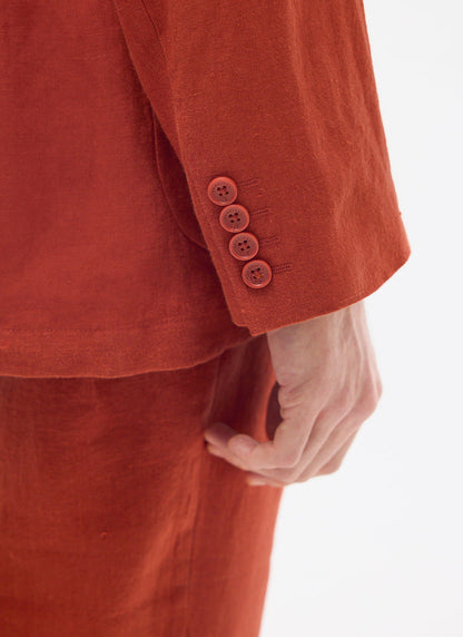 close up of rust linen blazer cuff with four Percival branded buttons