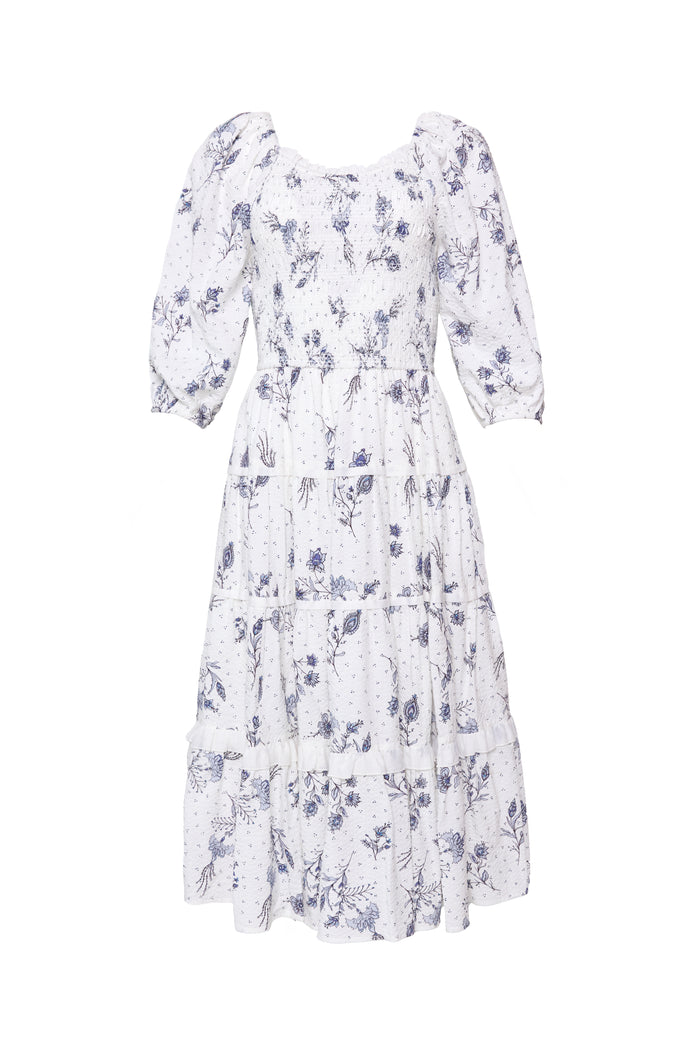 The Roselyn Dress in Blue Enchanted Floral by Ivy City Co is a white, knee-length dress with blue florals, puffed three-quarter sleeves, a tiered skirt, and a maternity-friendly design.