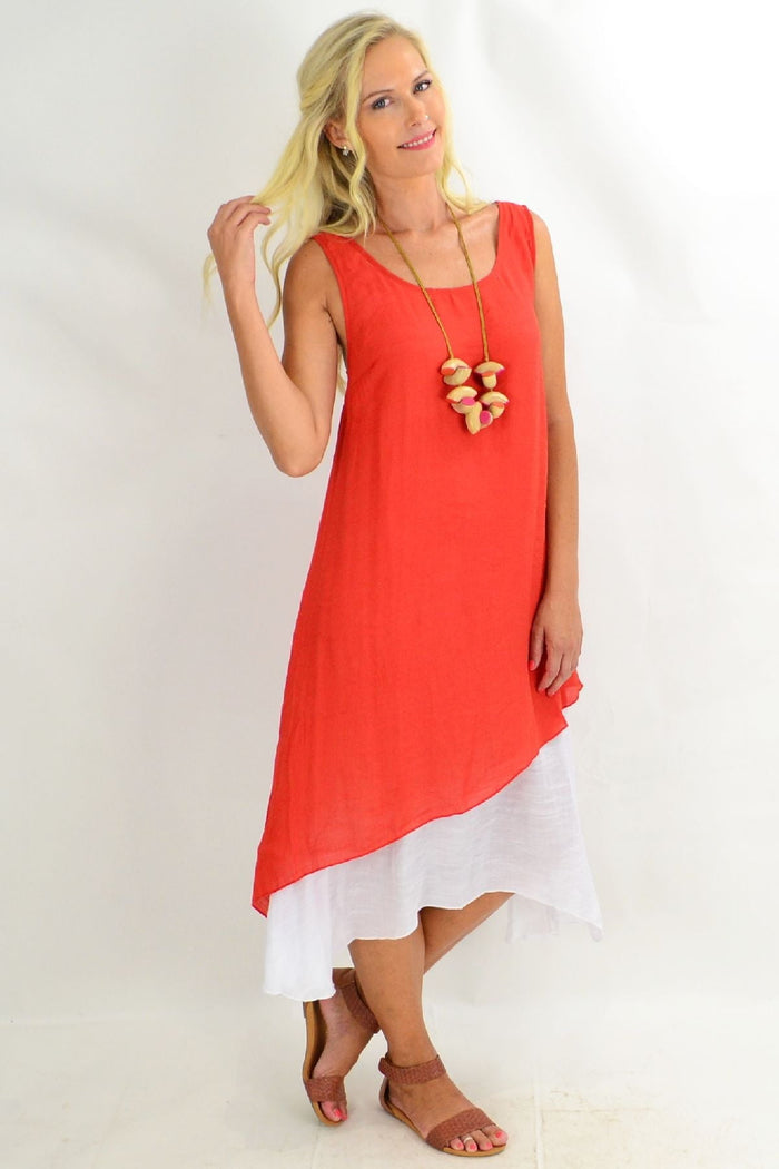 Rust asymmetrical hem tunic dress by Missy Q, featuring a flowy silhouette and stylish design, displayed on a hanger.