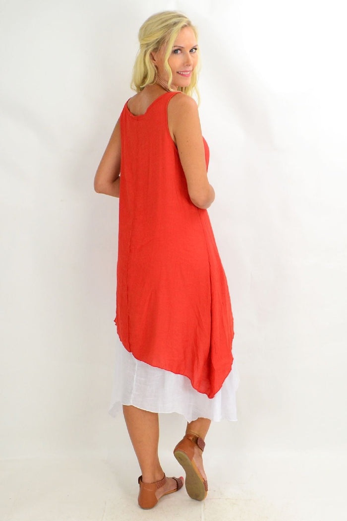 Rust asymmetrical hem tunic dress by Missy Q, featuring a flowing design and unique hemline, displayed on a hanger.