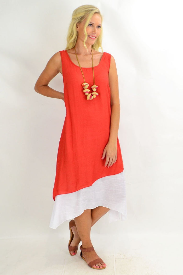 Rust Missy Q asymmetrical hem tunic dress displayed on a hanger with a relaxed fit and stylish design.