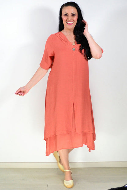 Rust-colored La Mode summer tunic dress with long sleeves and a relaxed fit, displayed on a hanger.