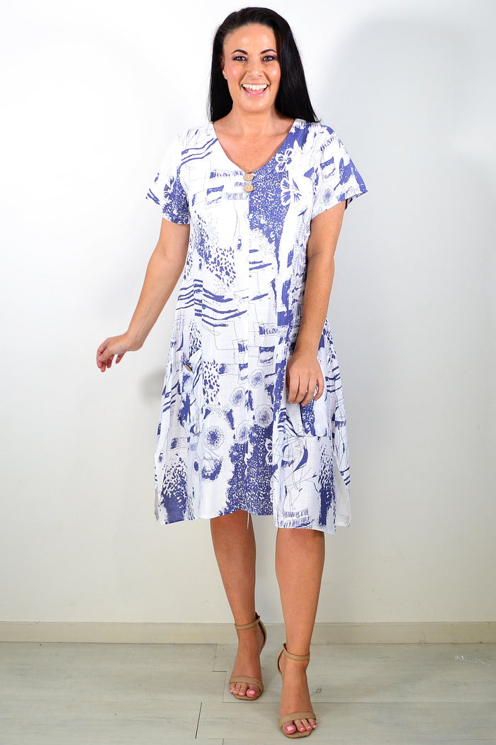 Ruby Rain Sail Away short sleeves tunic dress hanging on a mannequin, lightweight fabric with nautical print design.