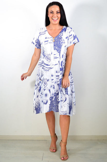Ruby Rain Sail Away short sleeves tunic dress hanging on a mannequin, lightweight fabric with nautical print design.